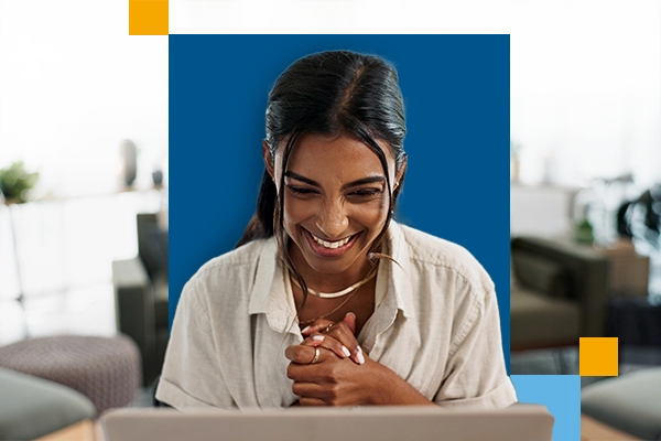 excited professional woman in front of computer